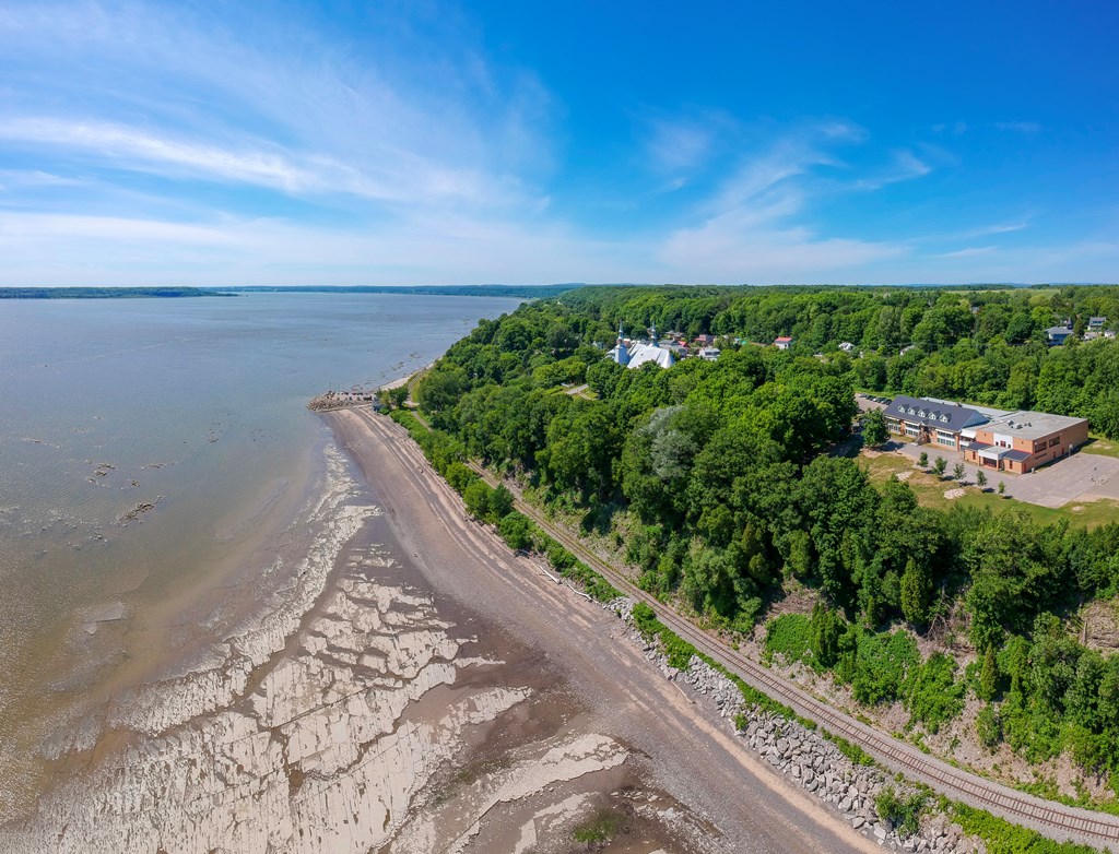 Aerial view of Saint Lawrence river at Cap-Sante with a railway and a beach 