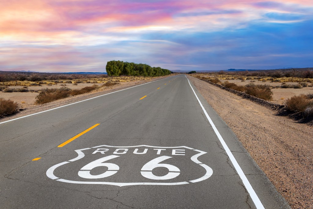 Route 66 shield marker on the highway in the Mojave Desert